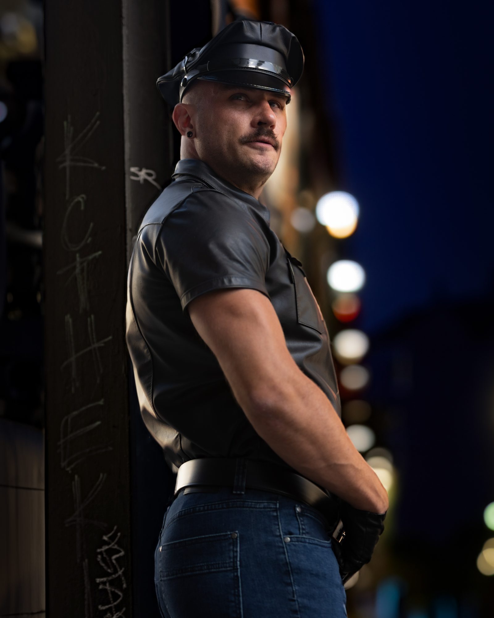 A relatable, scene-real leather portrait by Nick Leoni, an everyday man lit to look like the strongest version of himself